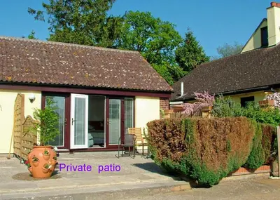 a house with a large vase in front of it at Annexe at Gosfield Lake in Gosfield