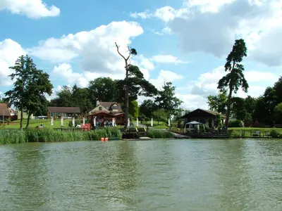 a view of a river with a house in the background at Annexe at Gosfield Lake in Gosfield