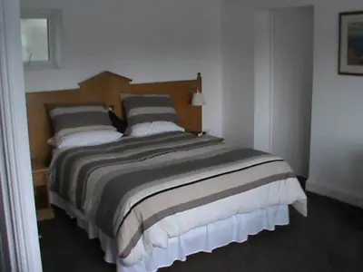 a bedroom with a large bed in a room at Annexe at Gosfield Lake in Gosfield