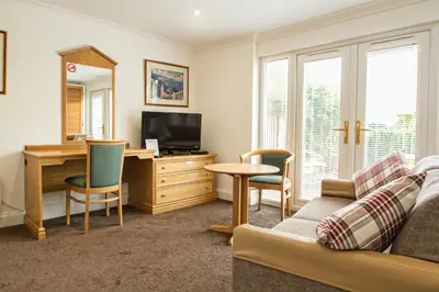 a living room with a couch and a desk at Annexe at Gosfield Lake in Gosfield