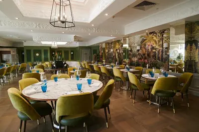 a restaurant with tables and chairs in a room at Down Hall Hotel in Bishops Stortford