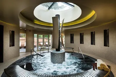 a hot tub in a building with a circular ceiling at Down Hall Hotel in Bishops Stortford