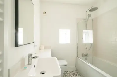a white bathroom with a sink and a shower at Volunteer Lodge, Leiston - Aldeburgh Coastal Cottages in Leiston