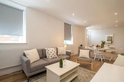 a living room with a couch and a table at Volunteer Lodge, Leiston - Aldeburgh Coastal Cottages in Leiston