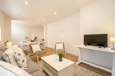 a living room with a couch and a tv at Volunteer Lodge, Leiston - Aldeburgh Coastal Cottages in Leiston