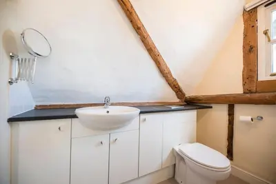 a bathroom with a sink and a toilet at Anchor Cottage, Orford in Woodbridge