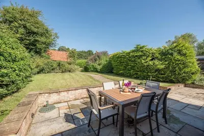 a table and chairs sitting on a patio at Anchor Cottage, Orford in Woodbridge