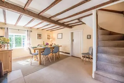 a kitchen and dining room with a table and chairs at Anchor Cottage, Orford in Woodbridge