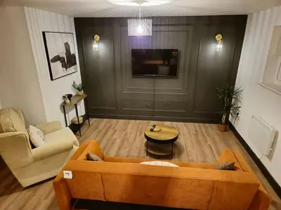 a living room with a couch and a table at Contractors l FreeParking l Station l Students in Colchester