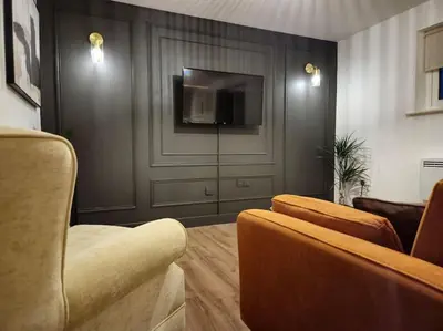 a living room with a couch and a flat screen tv at Contractors l FreeParking l Station l Students in Colchester