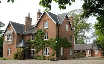 a large red brick house with a black roof at Orchard View in Bungay