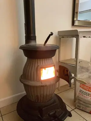 a wood fired grill with a light on the floor at Sam's Stable in Bungay