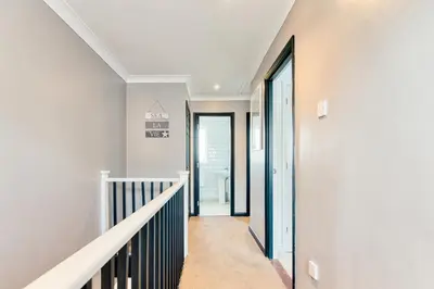 a hallway with white walls and a stairway at Beautiful Aldeburgh Coastal Getaway in Aldeburgh