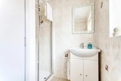 a bathroom with a sink and a shower at Beautiful Aldeburgh Coastal Getaway in Aldeburgh
