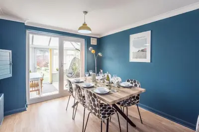 a dining room with a wooden table and chairs at Beautiful Aldeburgh Coastal Getaway in Aldeburgh