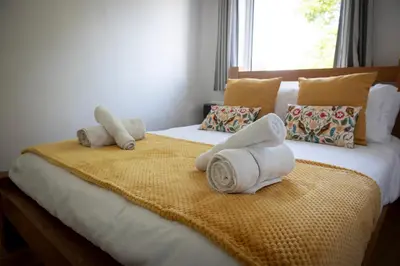 a bedroom with two towels on a bed at Pheasants Rest in Bar Hill