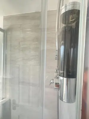 a shower in a bathroom with a glass door at Pheasants Rest in Bar Hill