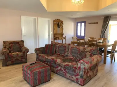 a living room with a couch and a table at Barn Owl Lodge with Hot Tub - Adults Only in Lackford
