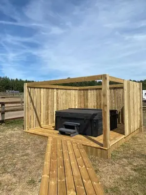 a wooden structure with a tv in it at Barn Owl Lodge with Hot Tub - Adults Only in Lackford
