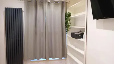 a bathroom with a shower curtain in a room at Number 14 in Ipswich