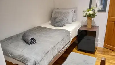 a bedroom with a bed and a vase of flowers at Number 14 in Ipswich