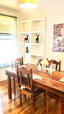 a dining room with a wooden table and chairs at Number 14 in Ipswich