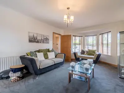 a living room with a couch and a table at Comfortable home Langdon Hills - Pass the Keys in Basildon