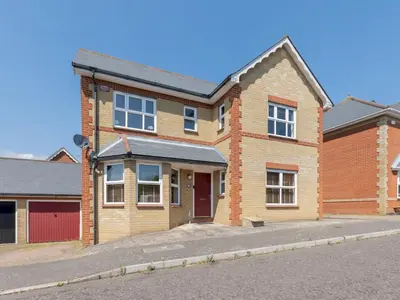 a brick house with a red door on a street at Comfortable home Langdon Hills - Pass the Keys in Basildon