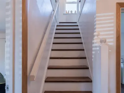 a staircase in a house with white walls at Comfortable home Langdon Hills - Pass the Keys in Basildon