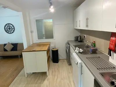 a kitchen with a sink and a counter top at Right by Leigh Broadway Private Garden large ground fl apt in Southend-on-Sea