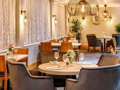 a dining room with a table and chairs at The Harlow Hotel By AccorHotels in Harlow