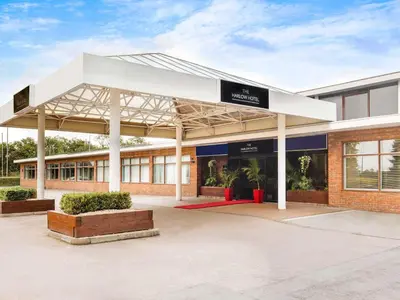 a building with a white canopy in front of it at The Harlow Hotel By AccorHotels in Harlow