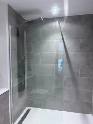 a shower with a glass door in a bathroom at The Sunrise Den-Lovely 2 bedroom apartmentParking in Harlow