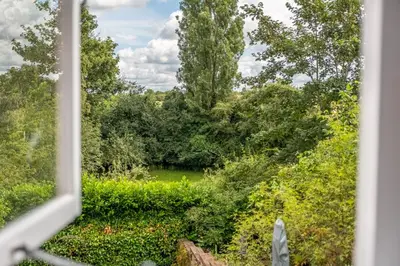 a view from a window of a garden at Brimming with Medieval charm - Weavers Cottage in Lavenham
