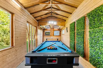 a pool table in the middle of a room at Spacious 4 Bed In Cambridge - Garden - Games Room in Cherry Hinton