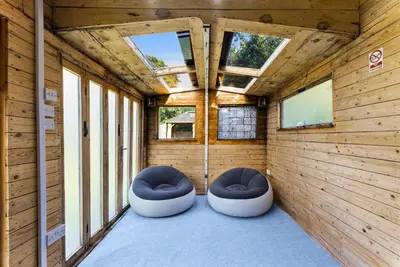two stools in the inside of a room with windows at Spacious 4 Bed In Cambridge - Garden - Games Room in Cherry Hinton