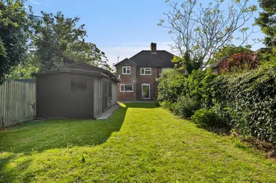 a yard with a house and a fence at Spacious 4 Bed In Cambridge - Garden - Games Room in Cherry Hinton