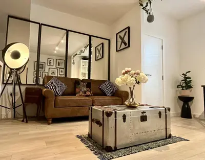 a living room with a couch and a vase of flowers at Modern Ipswich Waterfront Apartment Free Parking - Long Term Stays Available in Ipswich