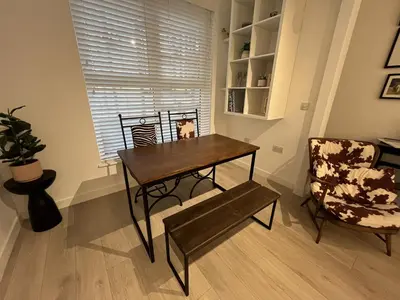 a dining room with a table and a chair at Modern Ipswich Waterfront Apartment Free Parking - Long Term Stays Available in Ipswich