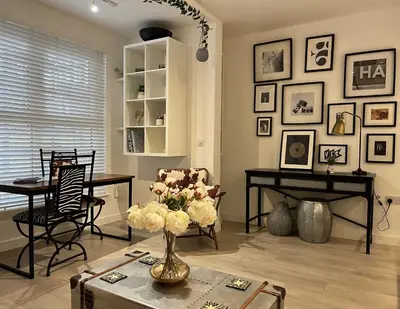 a living room with a vase of flowers on a table at Modern Ipswich Waterfront Apartment Free Parking - Long Term Stays Available in Ipswich
