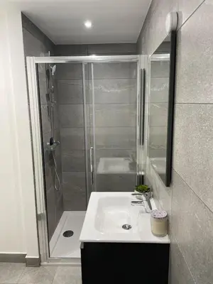 a bathroom with a white sink and a shower at Modern Ipswich Waterfront Apartment Free Parking - Long Term Stays Available in Ipswich