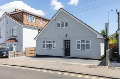 a white house on the side of a street at Stunning Spacious 4 Bed bungalow in Southend-on-Sea