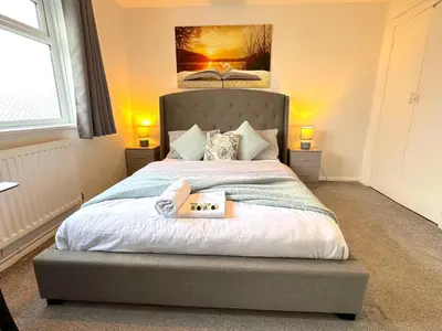 a bedroom with a bed with a book on it at Colchester City Luxury With Free Parking and 5 G WIFI in Colchester