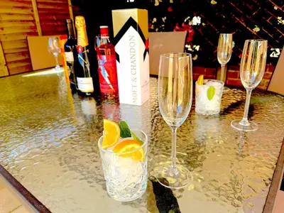 a table topped with glasses of champagne and oranges at Colchester City Luxury With Free Parking and 5 G WIFI in Colchester