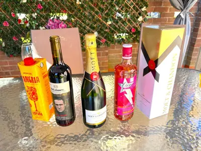 a table with two bottles of wine and a box at Colchester City Luxury With Free Parking and 5 G WIFI in Colchester
