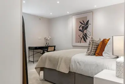 a white bedroom with a bed and a desk at Tailored Stays - Central Cambridge, Warkworth Lodge in Cambridge