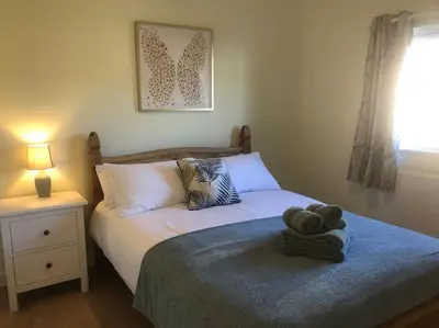 a bedroom with a bed with a towel on it at Wagtail Lodge in Lackford