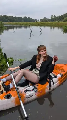 a woman sitting on a kayak in the water at Goldings Farm yurt Tent firepit bbq activities in Bramfield