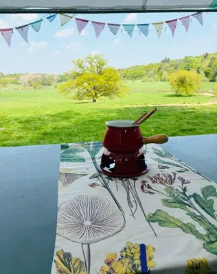 a red pot sitting on top of a table at Goldings Farm yurt Tent firepit bbq activities in Bramfield