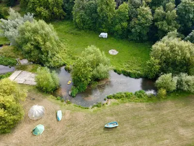 an aerial view of a river with boats in the grass at Goldings Farm yurt Tent firepit bbq activities in Bramfield